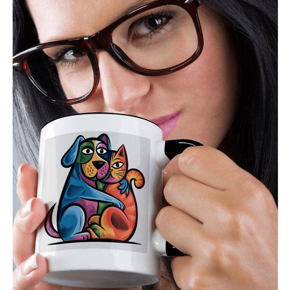 Person holding a mug with a colorful dog and cat design