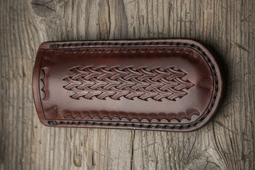 Brown leather wallet with woven pattern on a wooden surface