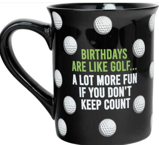 Black mug with golf ball patterns and humorous text on a white background